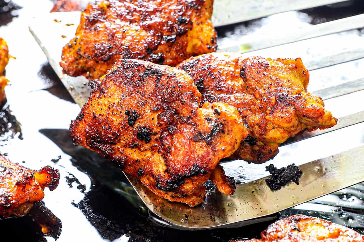 showing how to make butter chicken by searing chicken until charred in a skillet