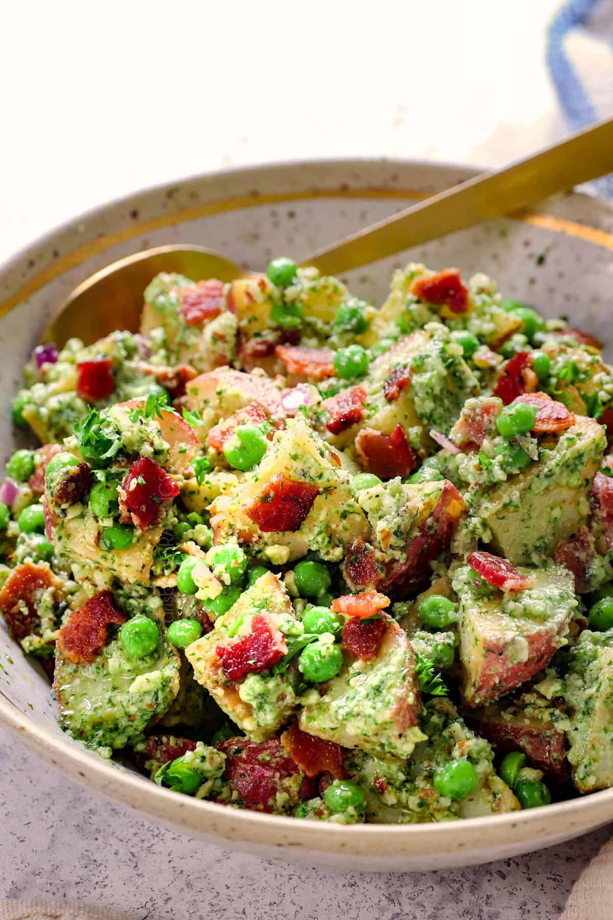 showing how to serve red potato salad in a serving bowl garnished by parsley