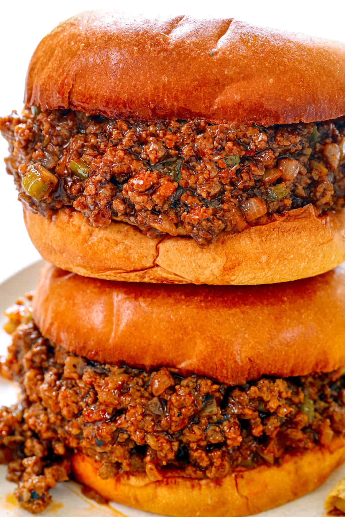 two Sloppy Joe's stacked on top of each other showing the sloppy filling