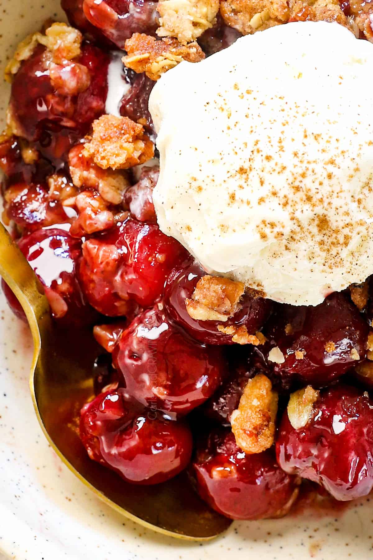 up close of cherry crisp recipe served with ice cream