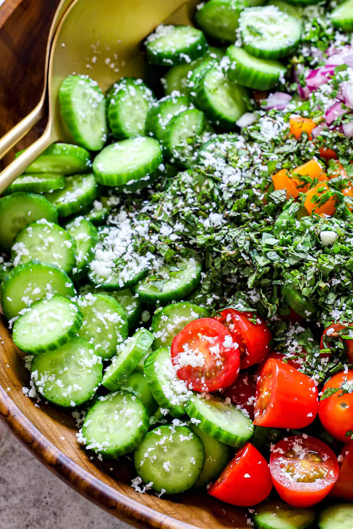 side view of a bowl showing ingredients for cucumber salad in a bowl
