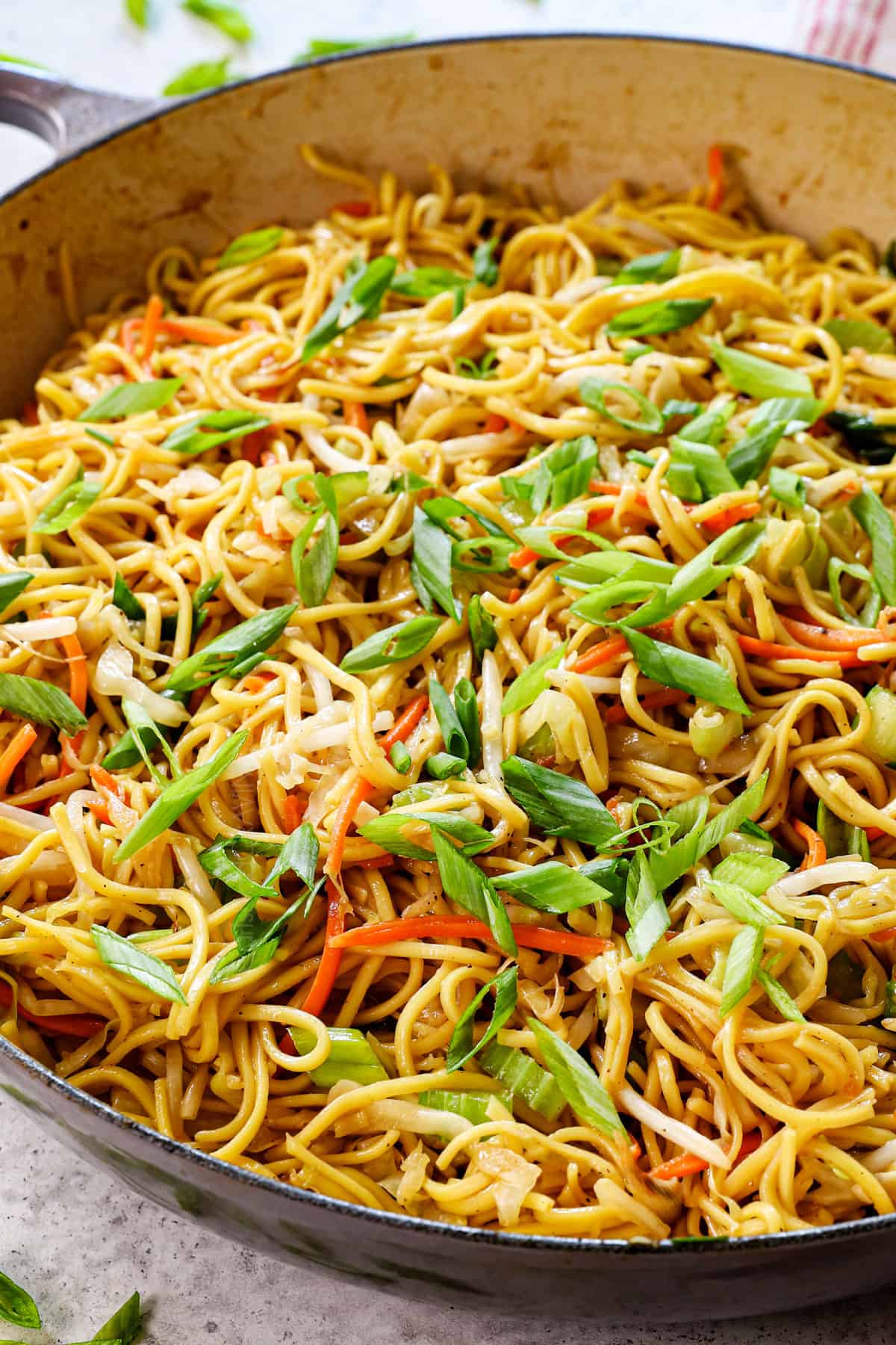 chow mein recipe made in a skillet or wok with cabbage, carrots and sprouts