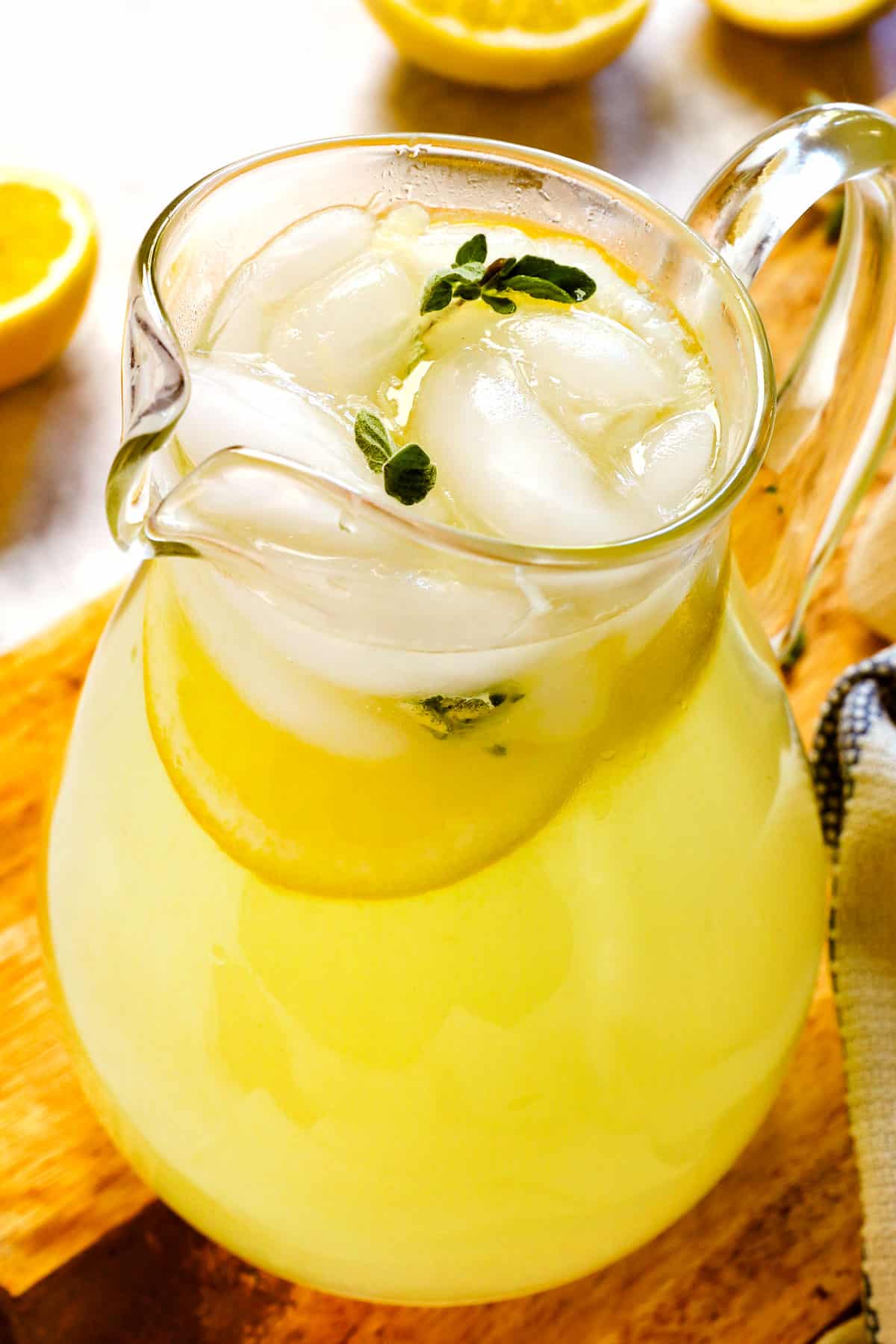 showing how to make best lemonade recipe by stirring ice into the lemonade before serving