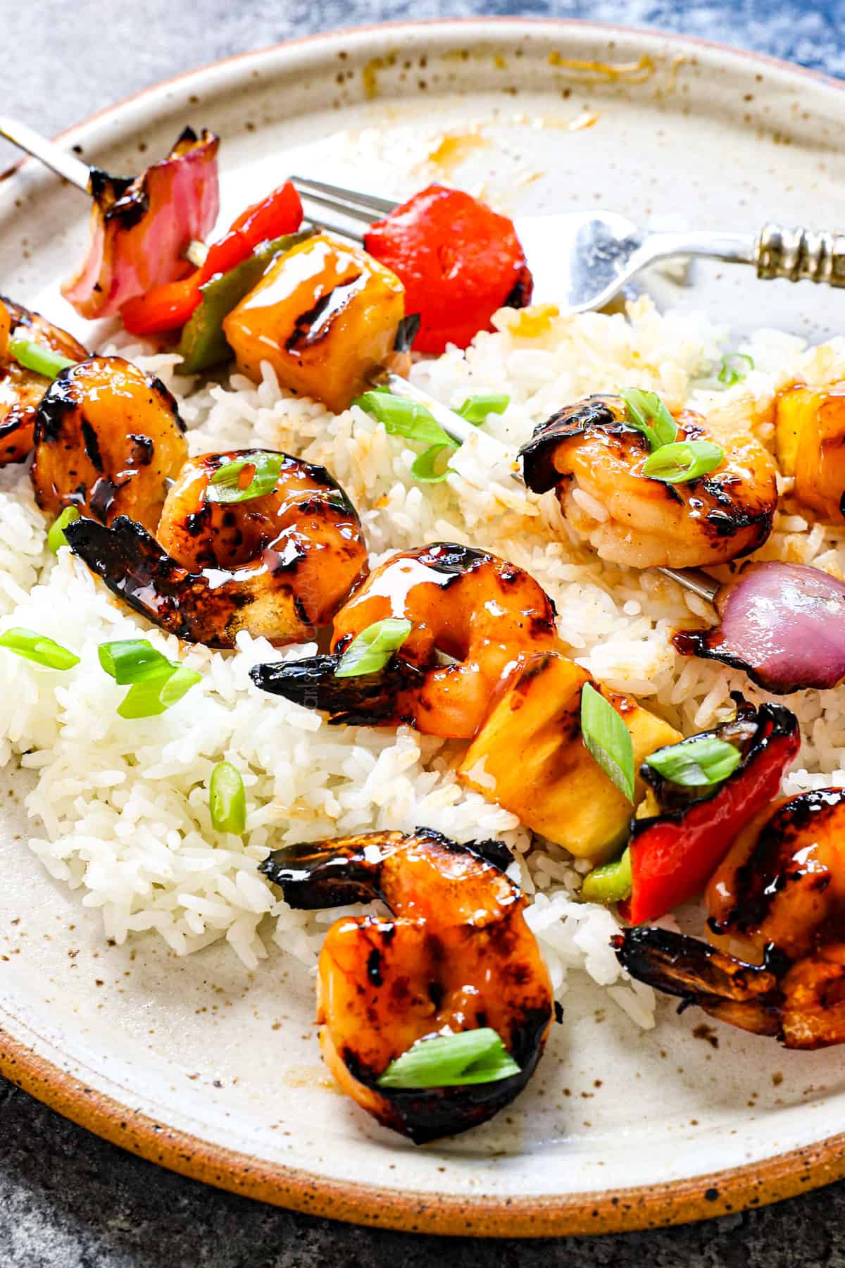 serving shrimp kabobs by taking shrimp off of the skewers