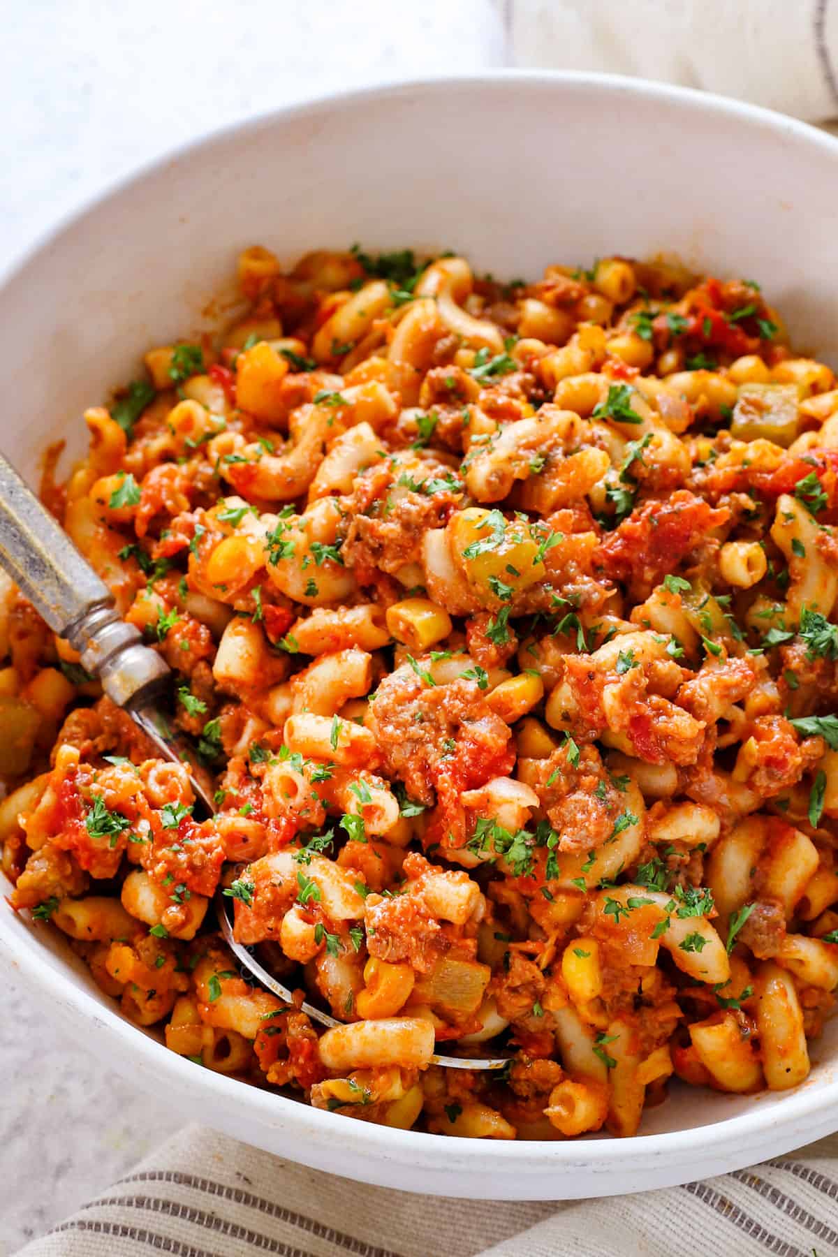 serving American Chop Suey in a bowl garnished with parsley