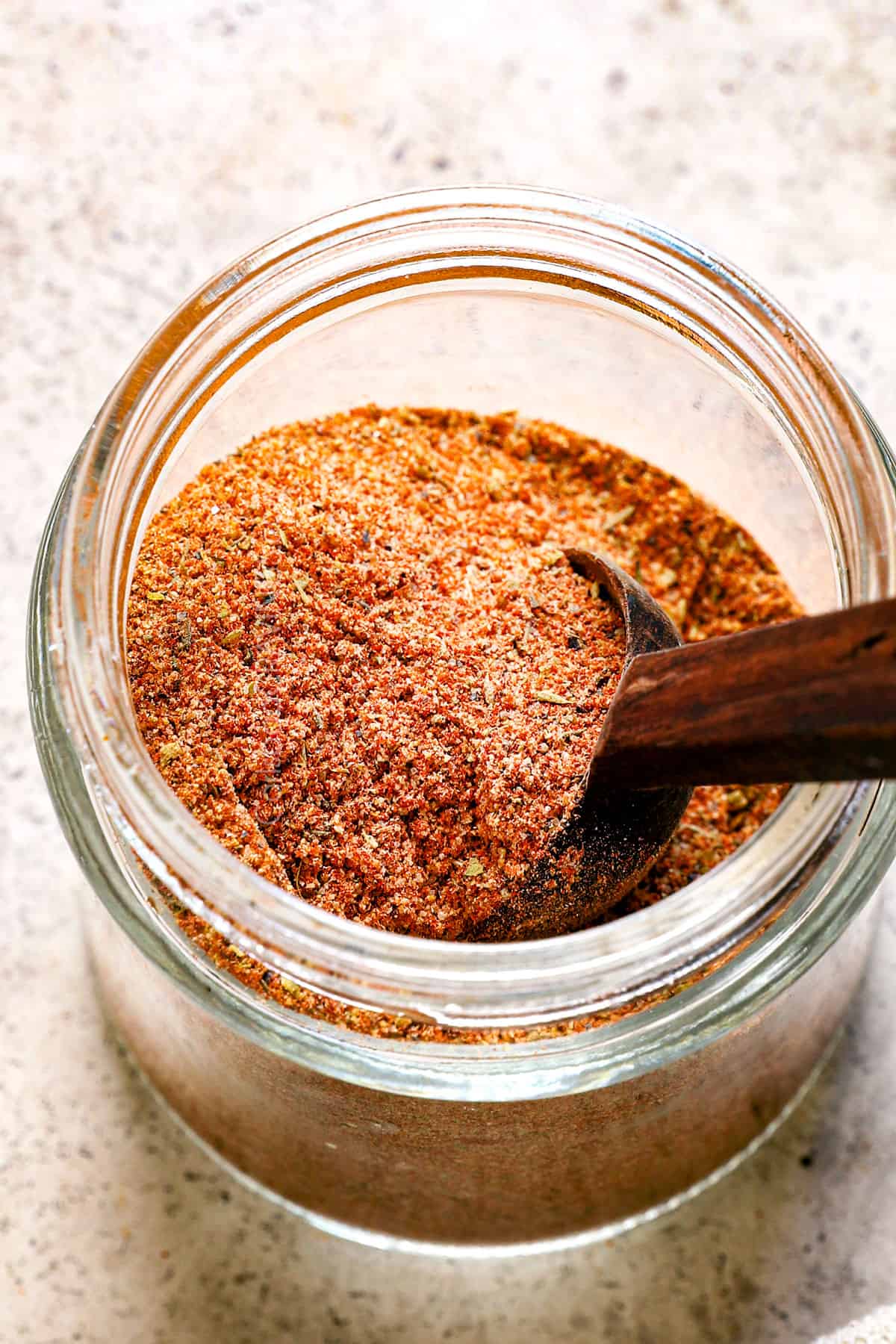 showing how to store homemade Cajun seasoning in a jar