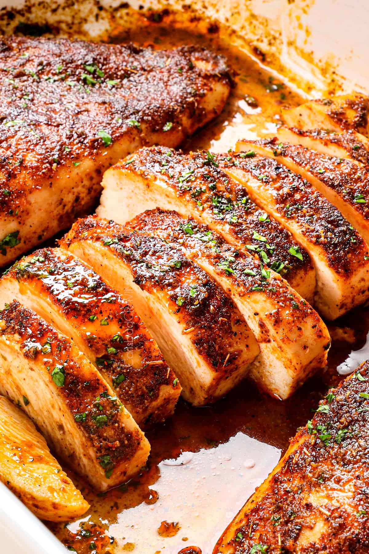 baked chicken breasts sliced and garnished with parsley
