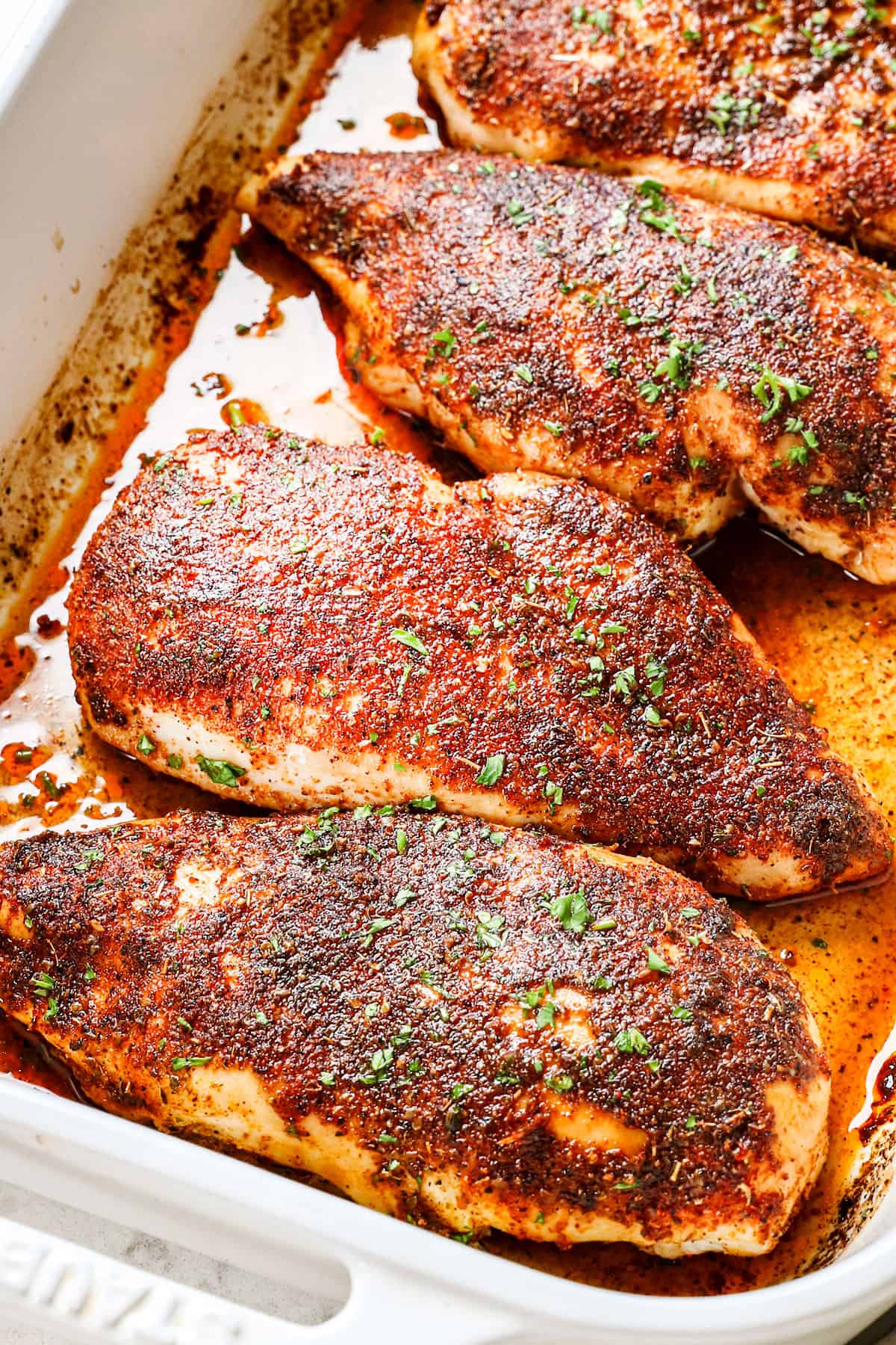 baked chicken breast recipe garnished with parsley