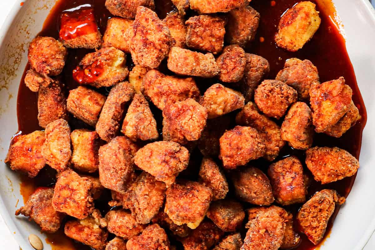 a collage showing how to make Korean fried chicken (yangnyeom) by tossing it in the gochujang sauce