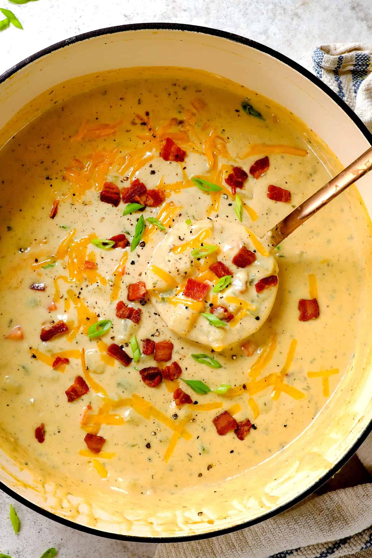 top view of best best potato soup recipe with a ladle spooning the soup