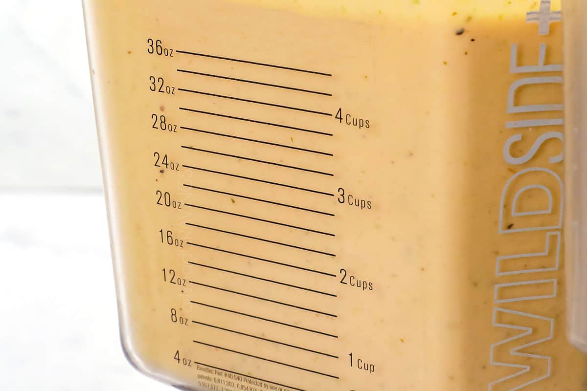 showing how to make potato soup by blending part of the soup in a blender until creamy