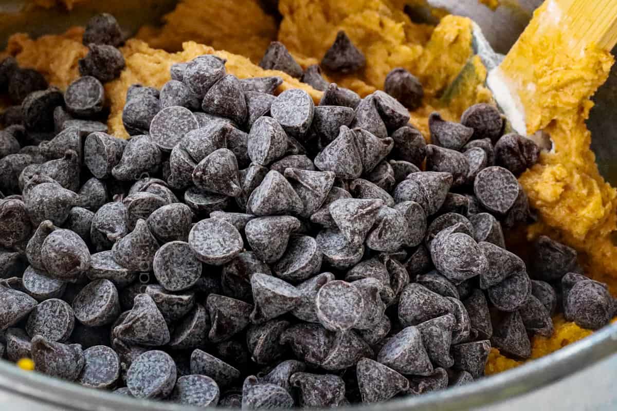 showing how to make pumpkin chocolate chip cookies by adding chocolate chip cookies