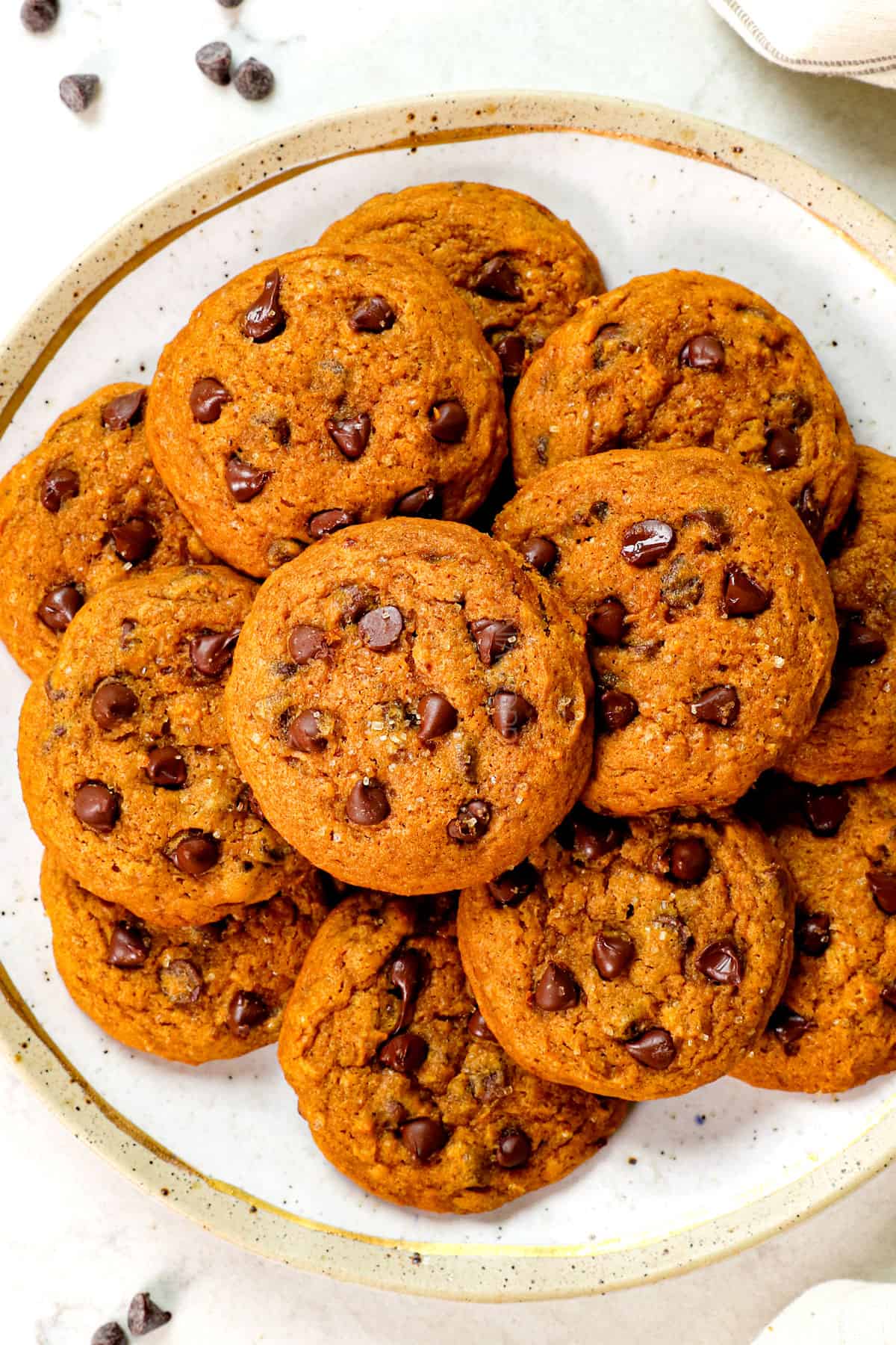 top view of pumpkin chocolate chip cookies on a plate showing how to serve them