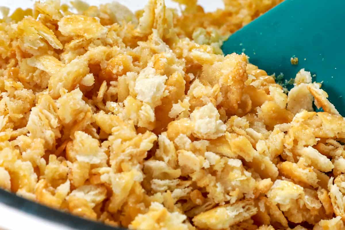 showing how to make broccoli casserole by mixing Ritz with butter in a bowl