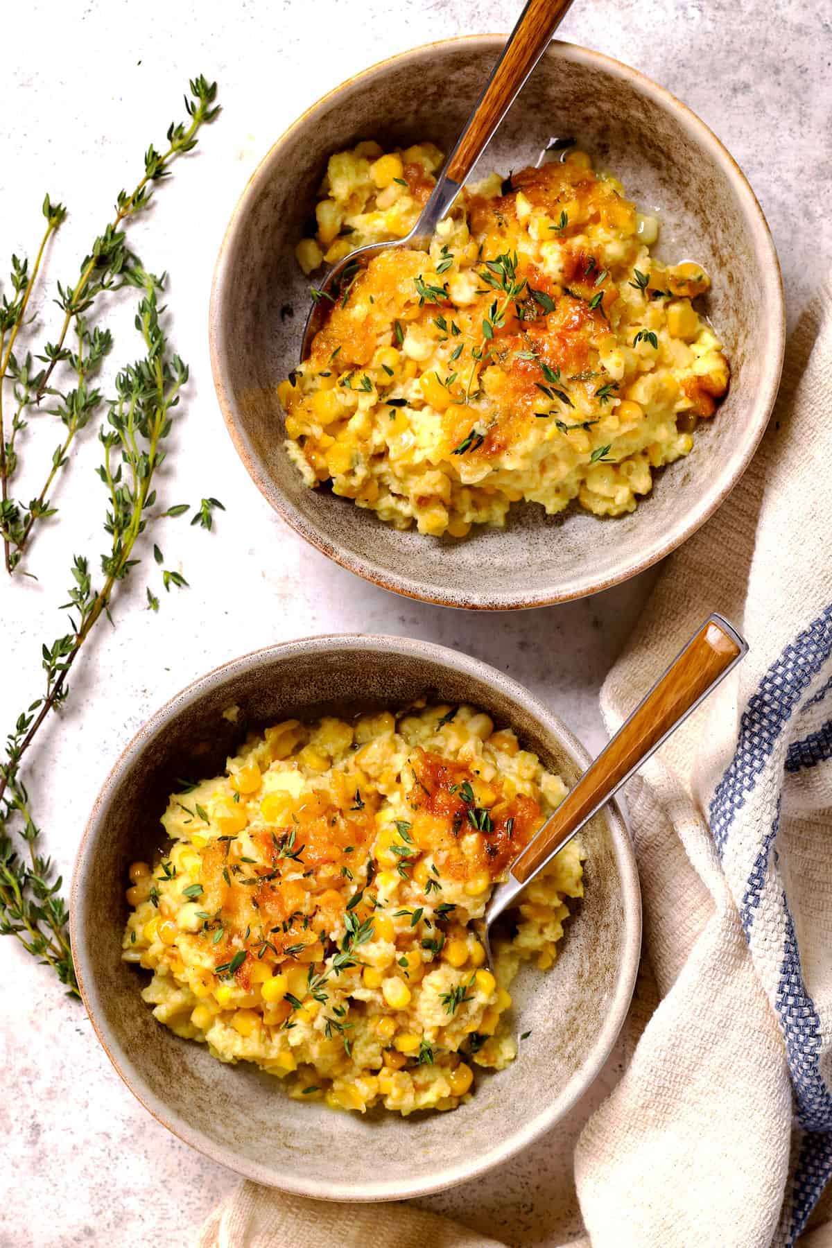 top view of showing how to serve corn pudding in two bowls eaten with spoons