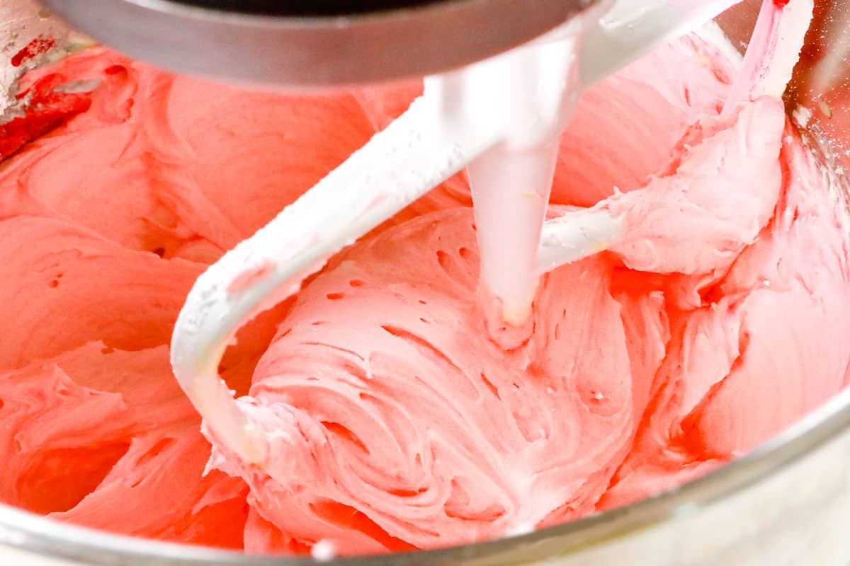 showing how to make sugar cookies by mixing frosting in a mixer