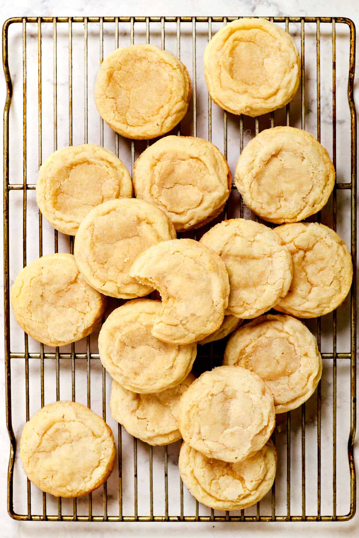 showing how to make sugar cookies by cooling on a wire rack before frosting