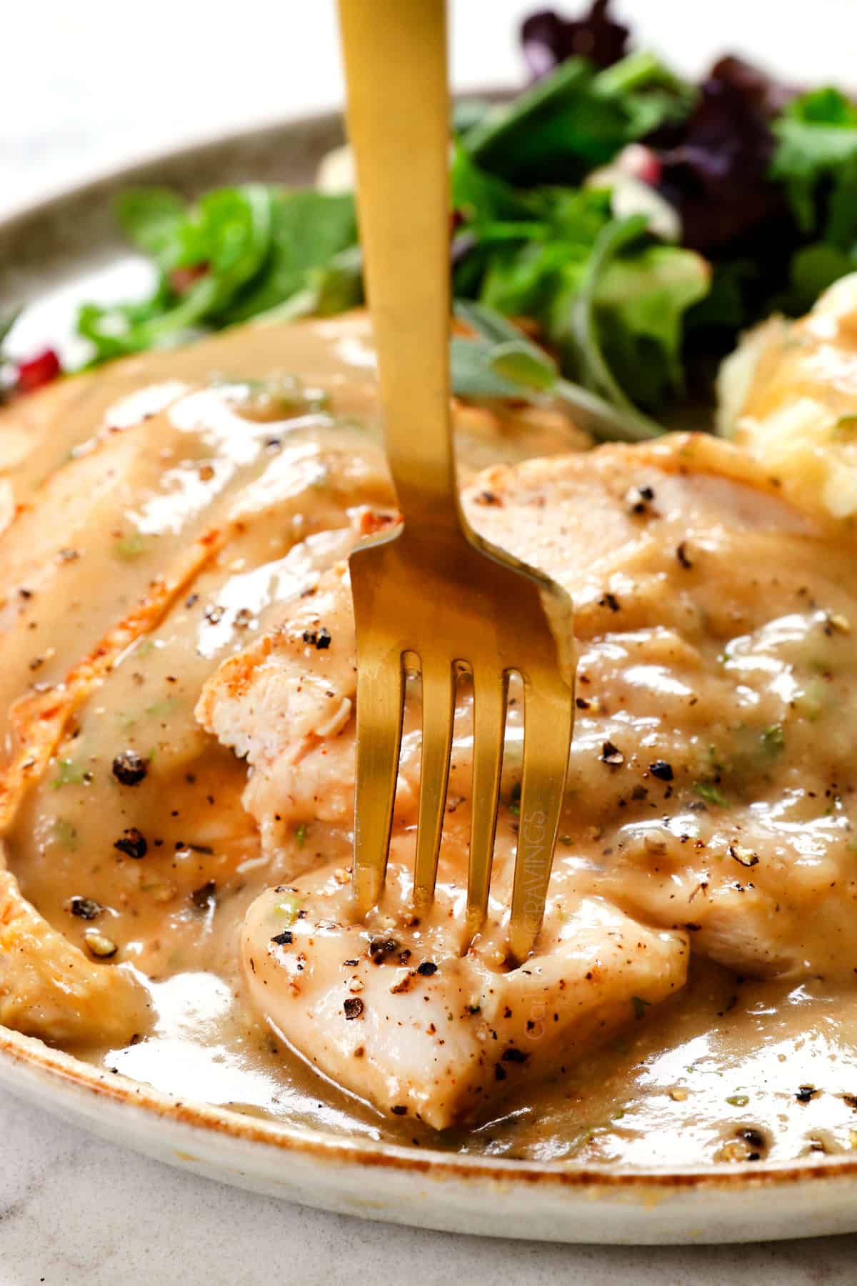 up close of taking a bite of turkey with homemade turkey gravy