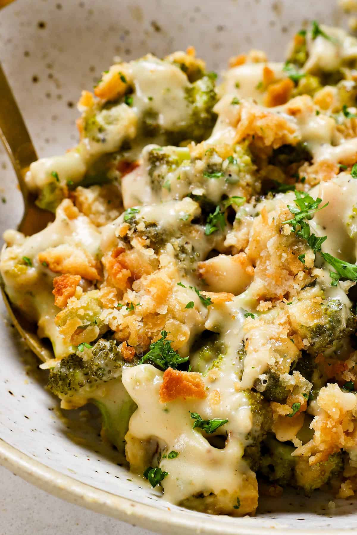 serving cheesy broccoli casserole in a plate