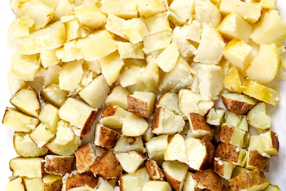 showing how to make twice baked potato casserole by removing skins from half of the potatoes, and cubing all potatoes