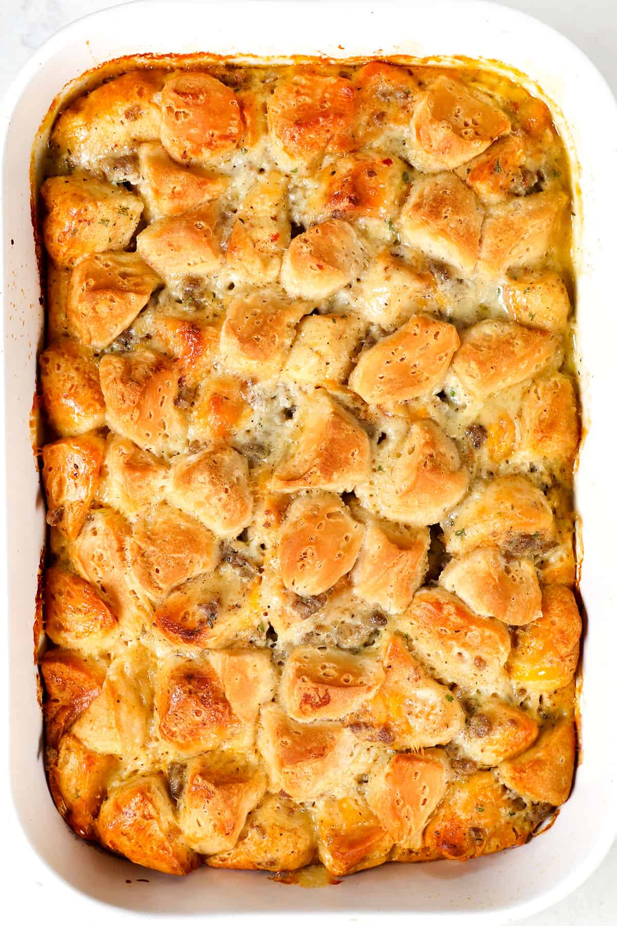 showing how to make biscuit and gravy casserole by baking until the eggs are set and the biscuits are golden