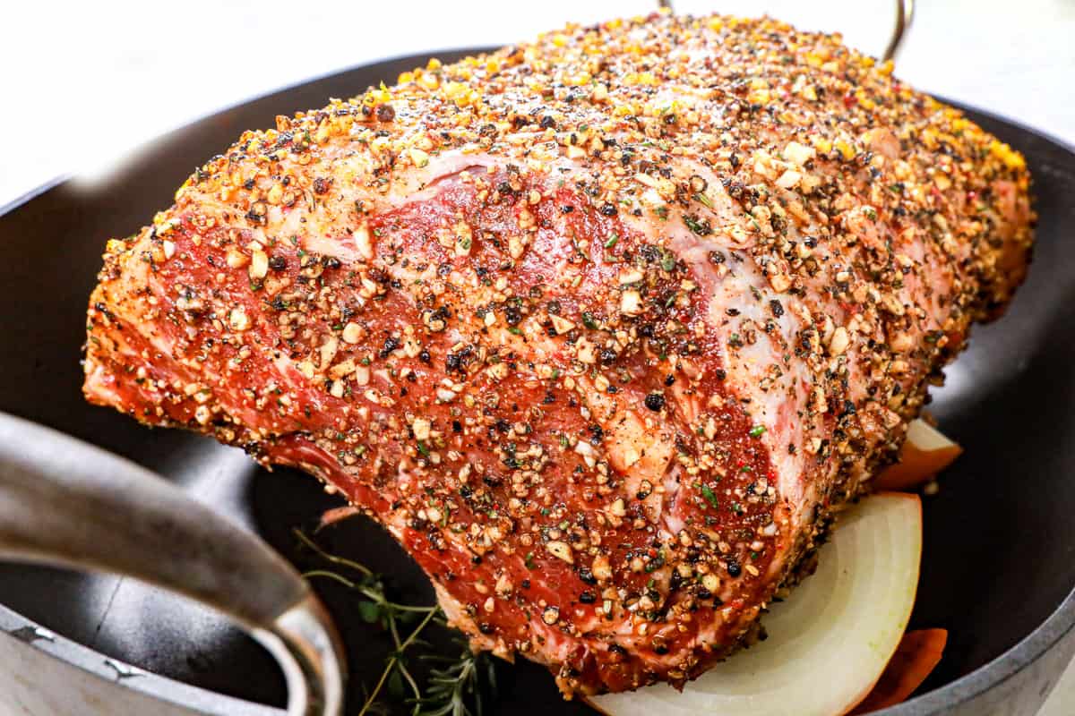 showing how to cook prime rib by placing prime rib in roasting pan and inserting a probe meat thermometer