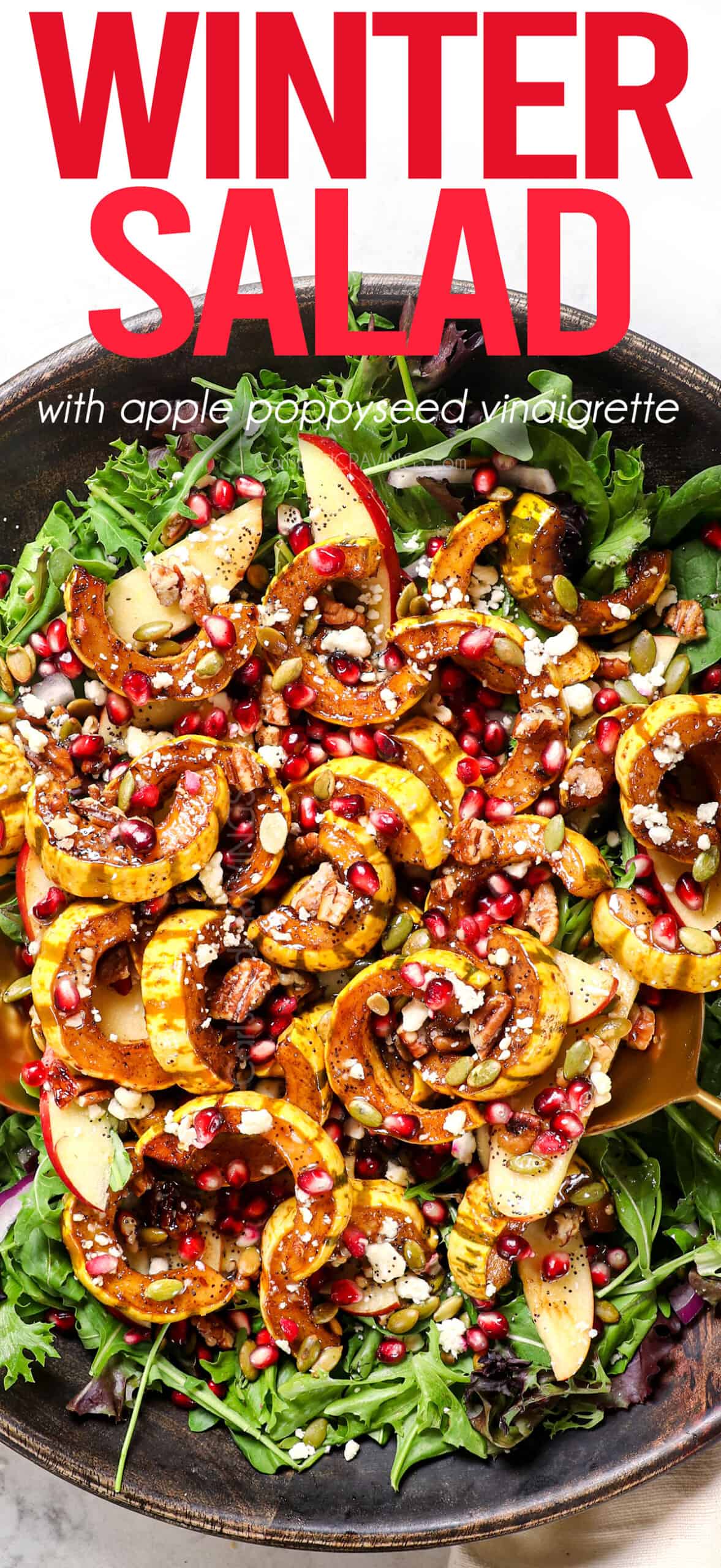 top view of tossing winter salad ingredients together in a bowl