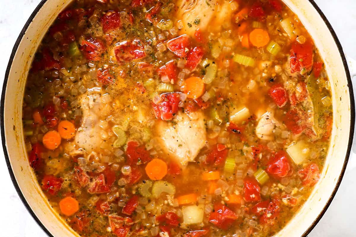 showing how to make chicken vegetable soup by simmering soup until chicken is tender enough to shred