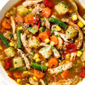 showing how to serve chicken vegetable soup in a bowl garnished with parsley