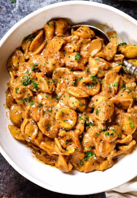 top view of serving French Onion Soup Pasta in a bowl garnished with parsley