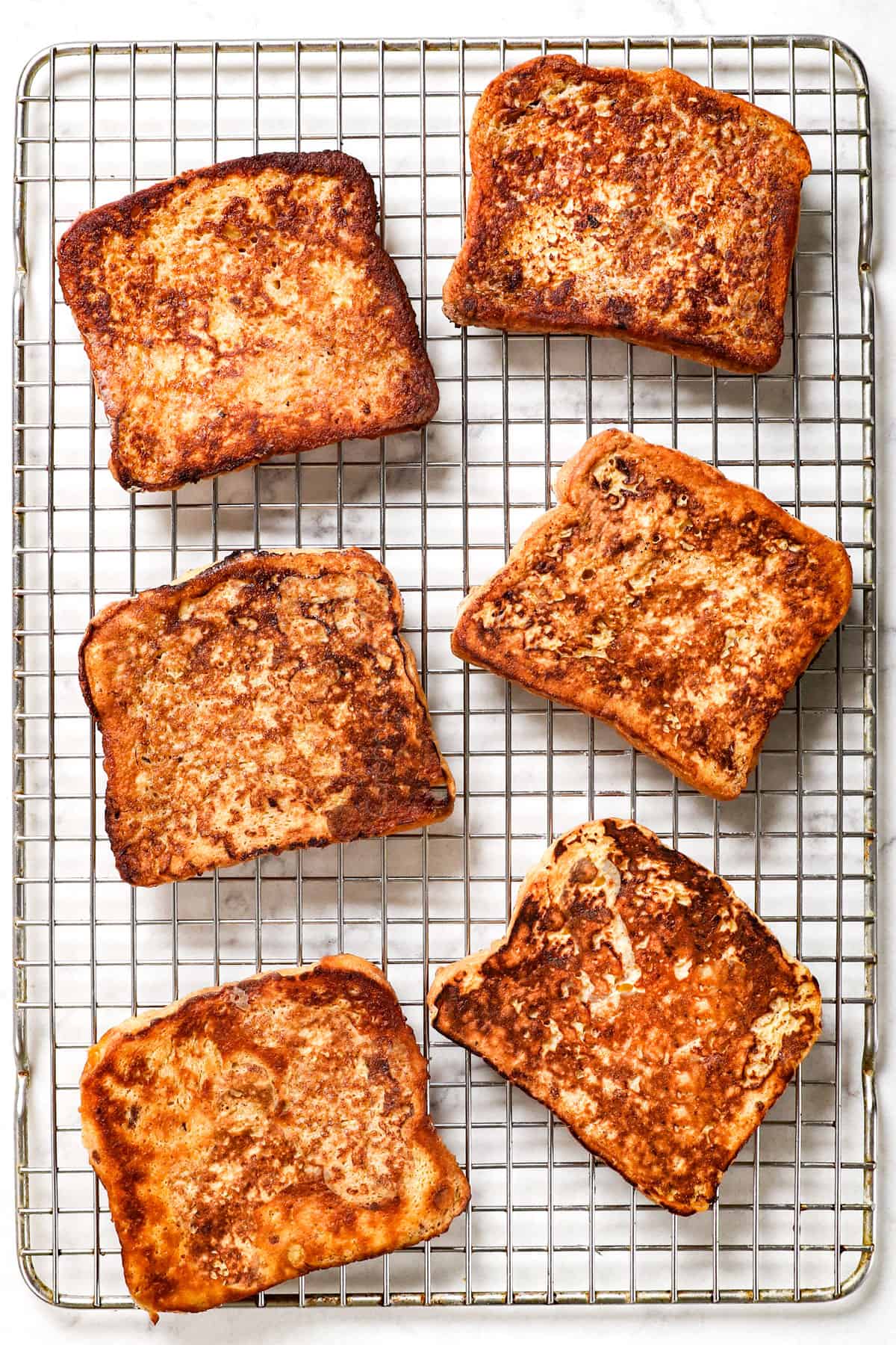 Step 5 showing how to make French Toast by letting French toast slices rest on a wire rack so they don't get soggy