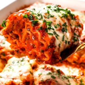 up close of serving a lasagna roll up showing how meaty and cheesy it is