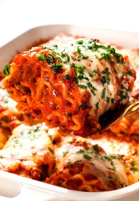 up close of serving a lasagna roll up showing how meaty and cheesy it is