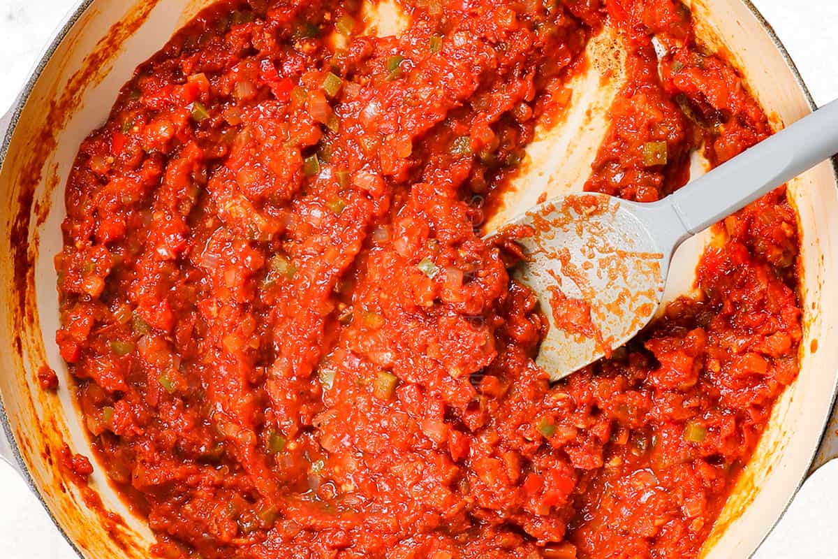 showing how to make shakshuka recipe by simmering the sauce until thickened