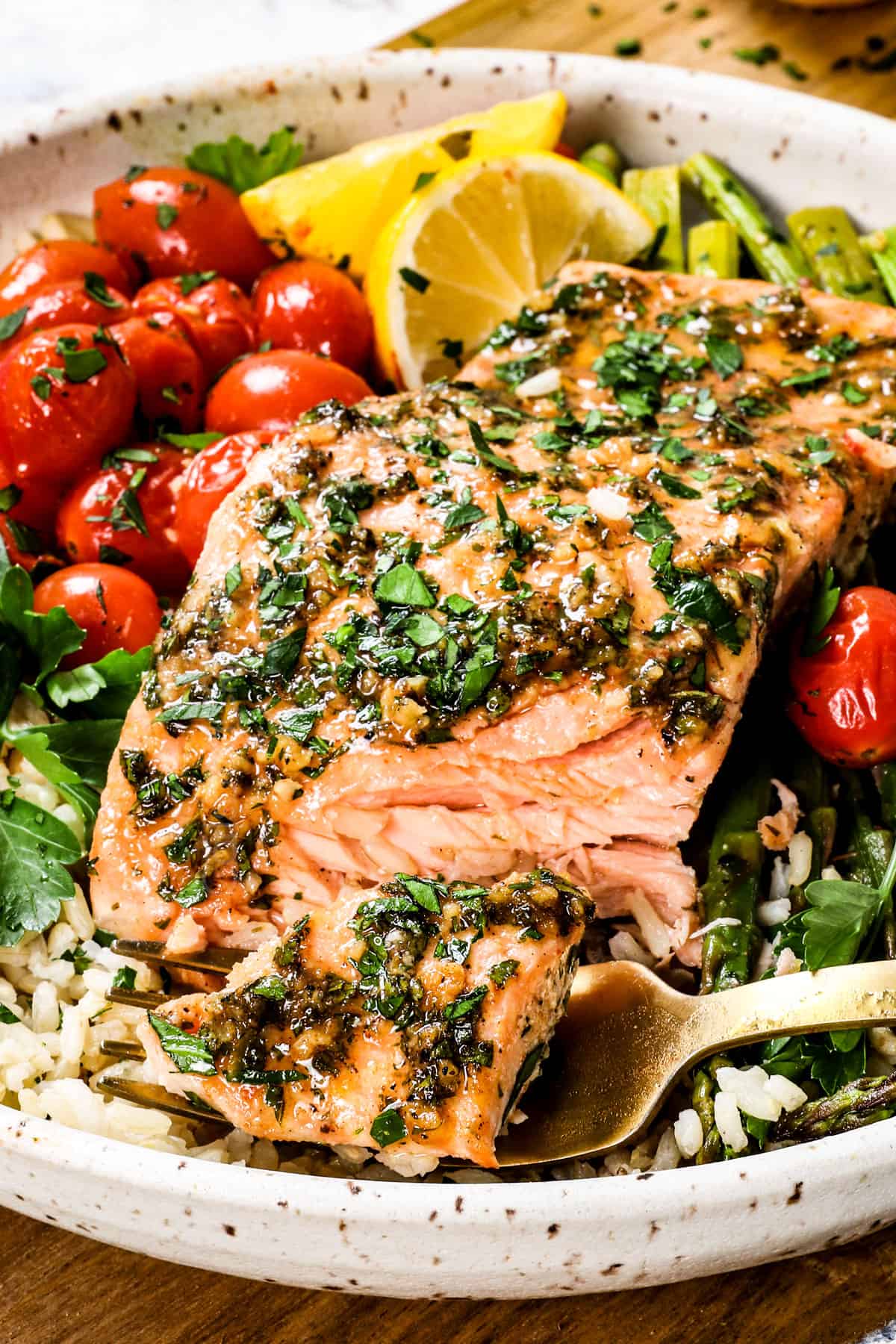 up close of a bite out of oven baked salmon recipe showing how tender and juicy it is