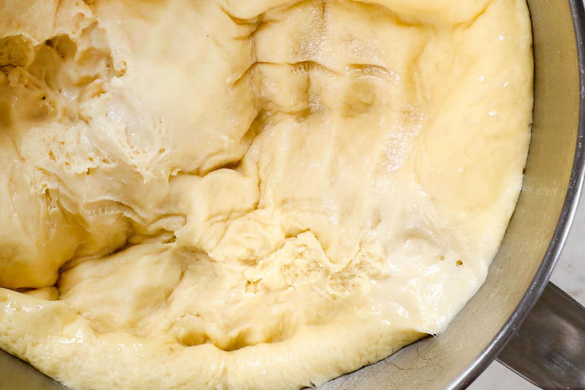 showing how to make beignets recipe by punching down the dough and letting it rise for 30 minutes