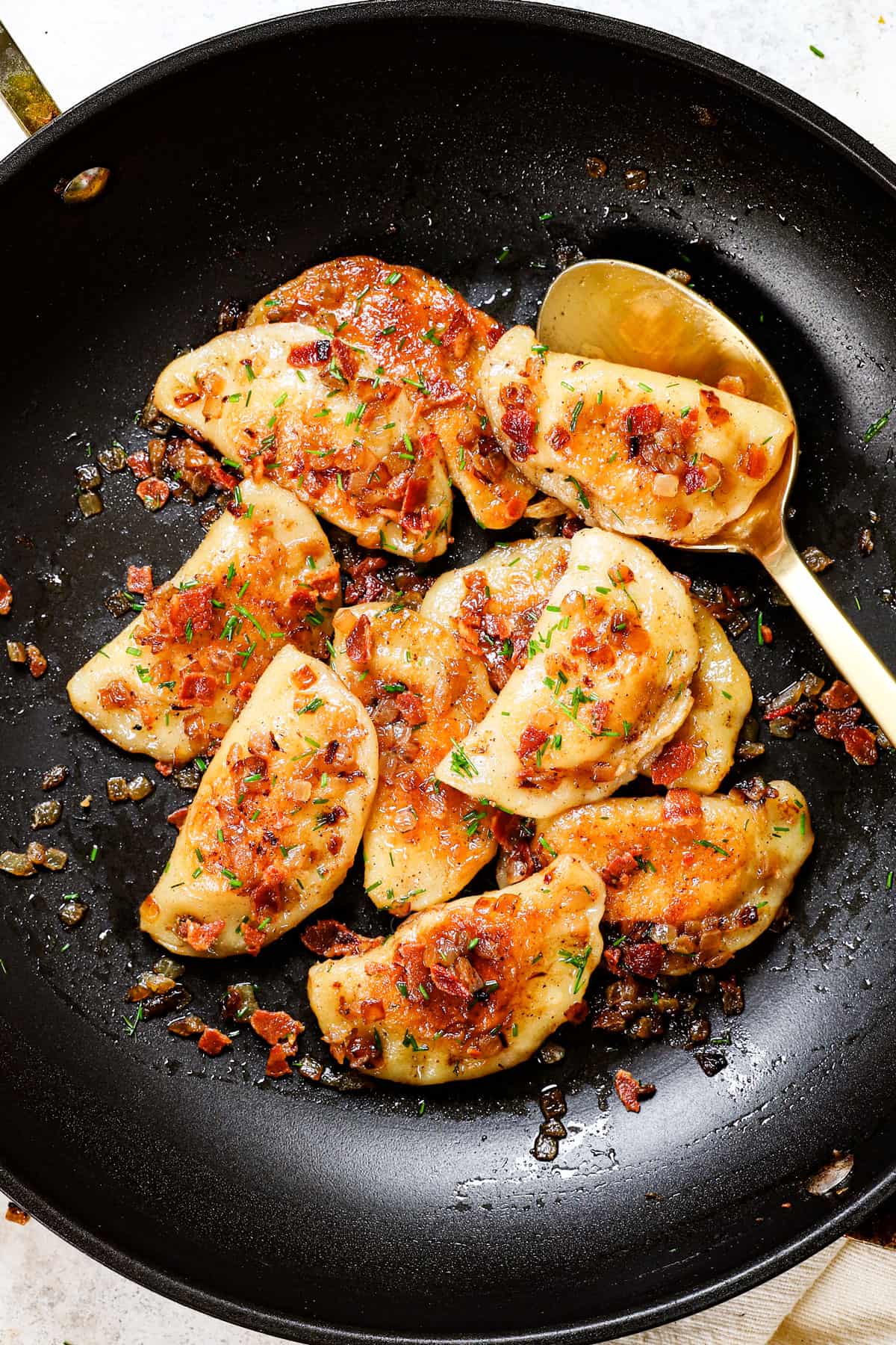 top view showing how to make pierogi recipe by tossing with pierogi sauce