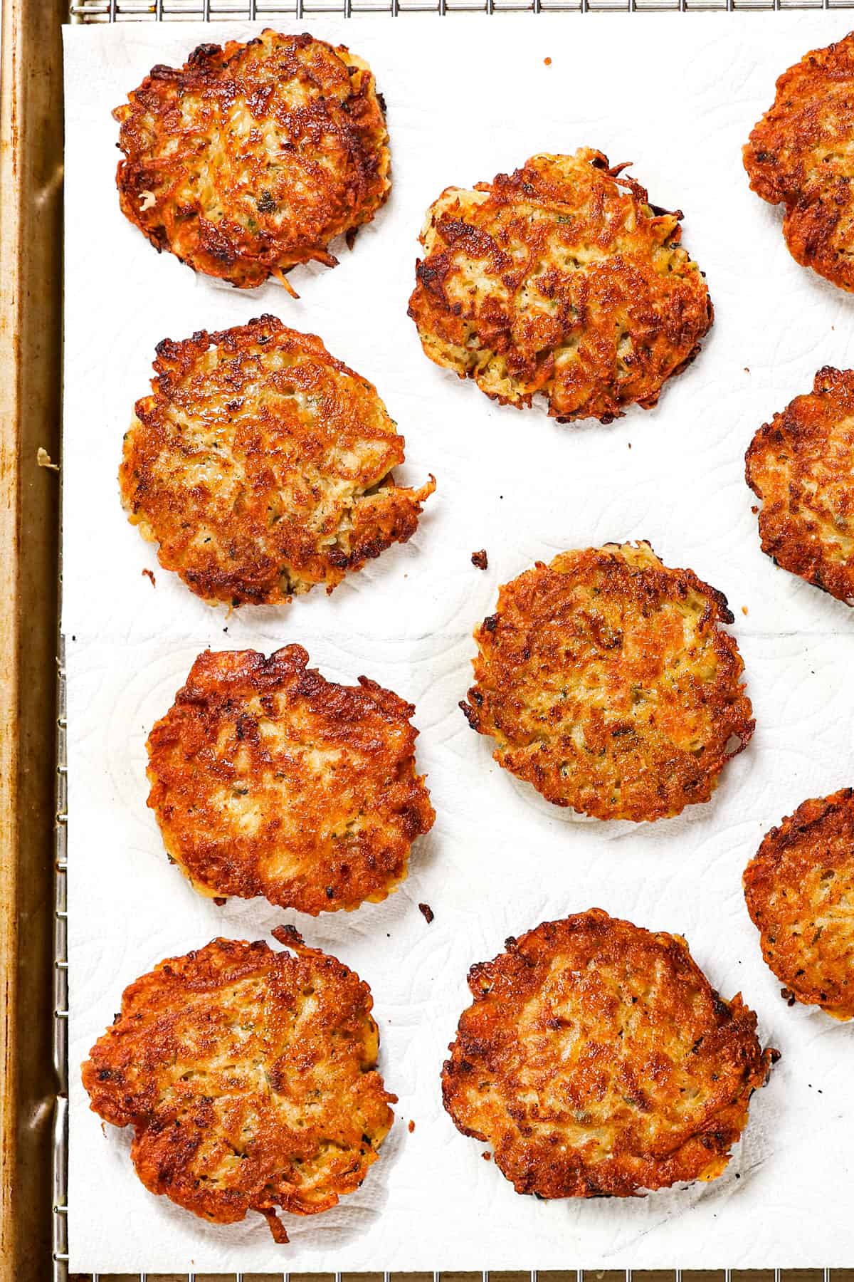 showing how to make potato pancakes by draining pancakes on paper towels