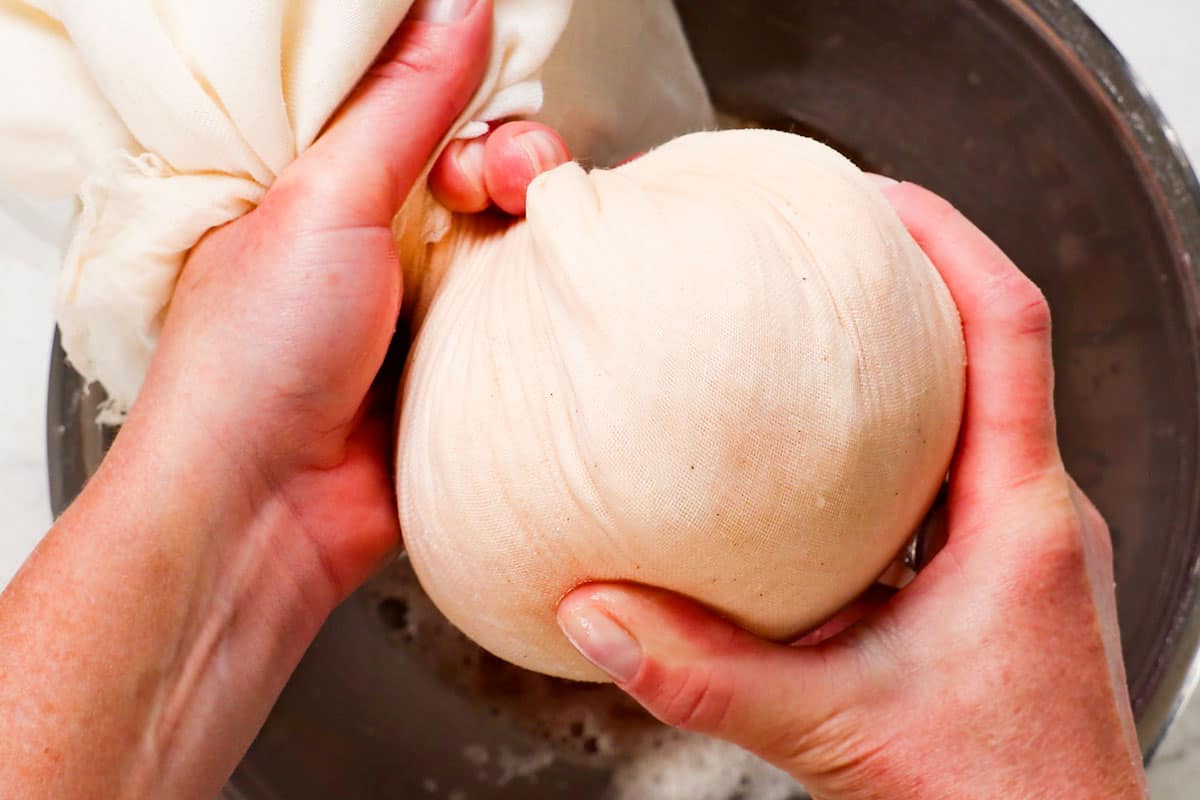 showing how to make potato pancakes by wringing out excess liquid