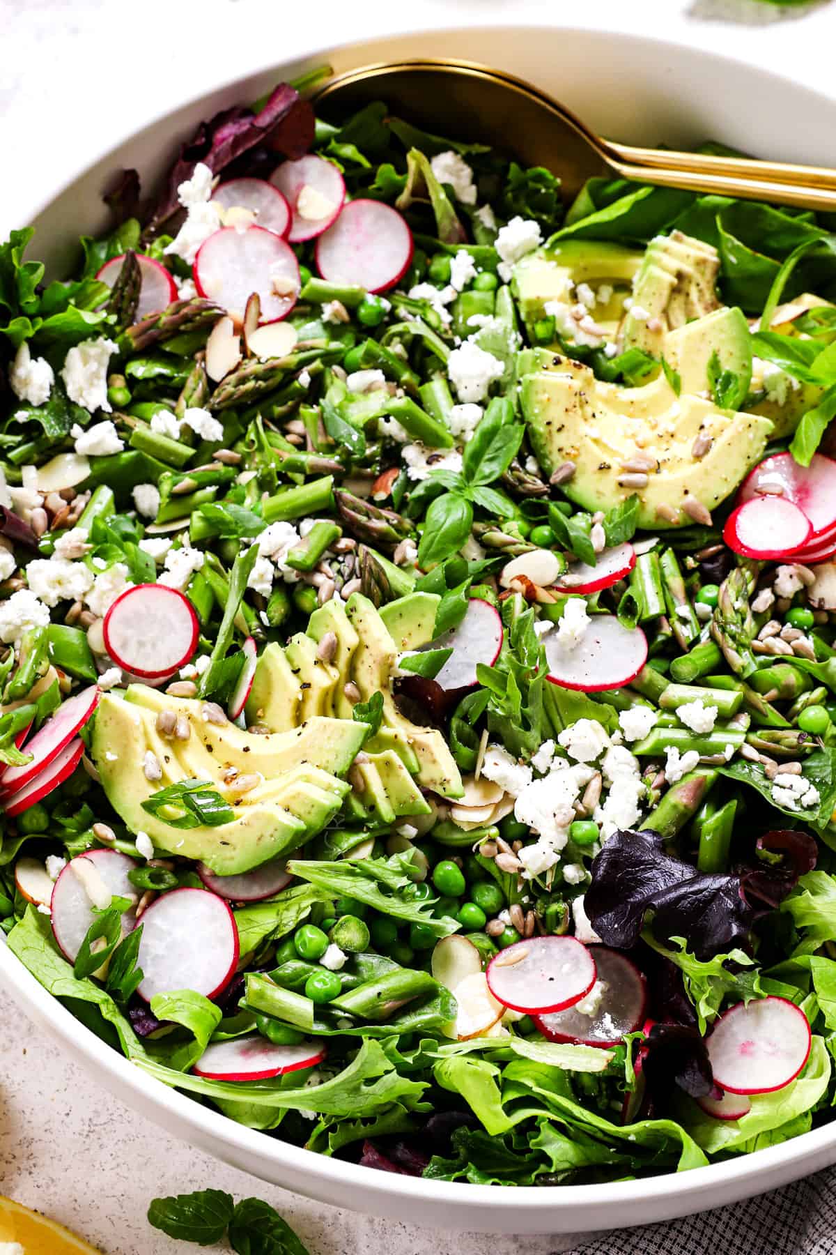 spring mix salad recipe in a large serving bowl showing all the ingredients