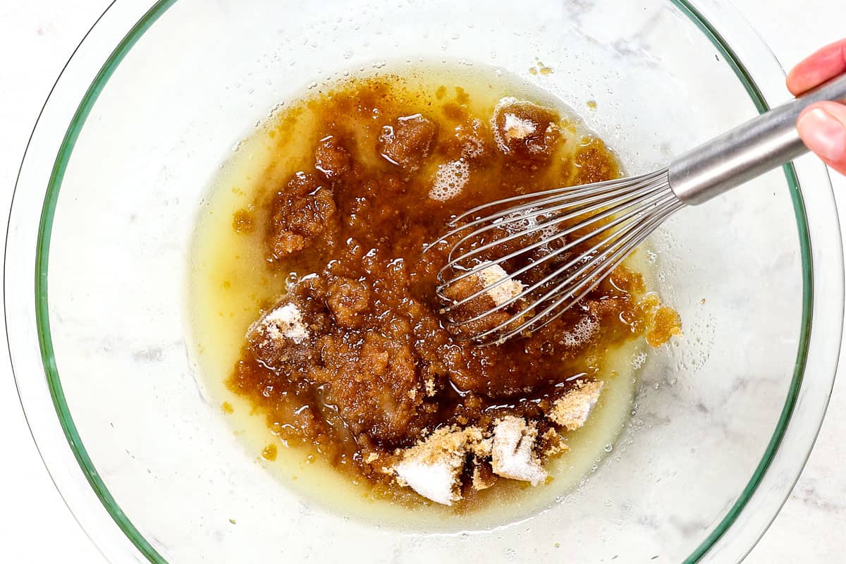 showing how to make pizookie by whisking butter with brown sugar and granulated sugar