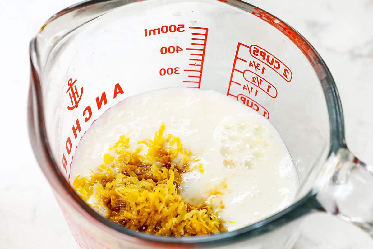 showing how to make lemon poppy seed cake by whisking together buttermilk, lemon juice and lemon zest