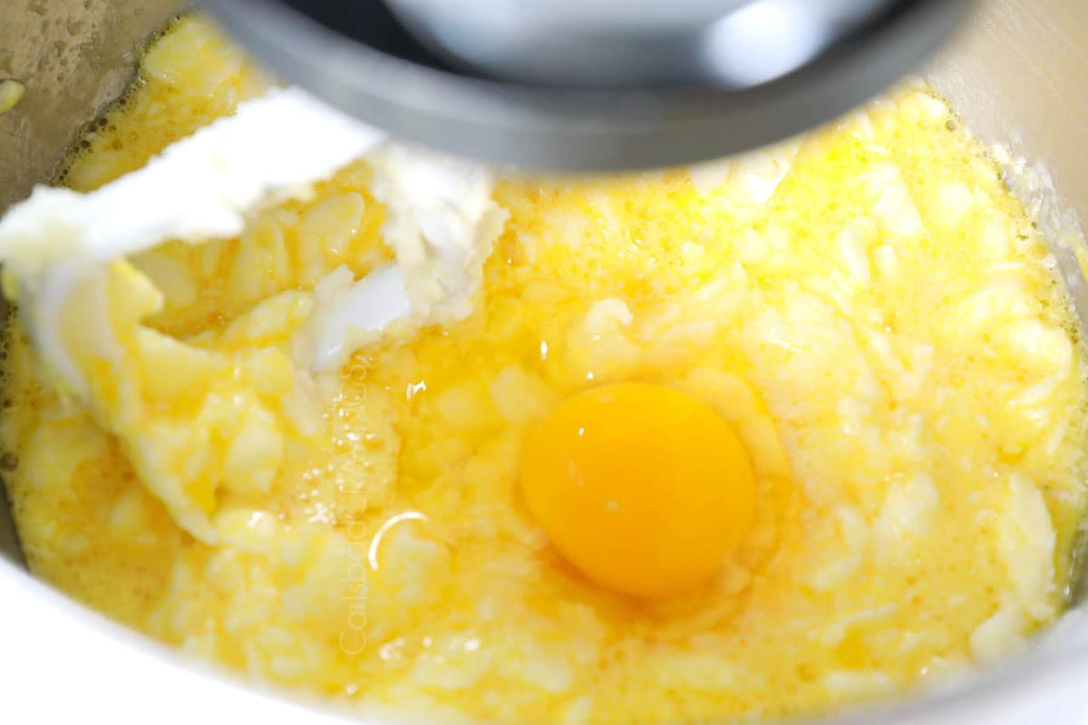 showing how to make lemon poppy seed cake by beating in the eggs