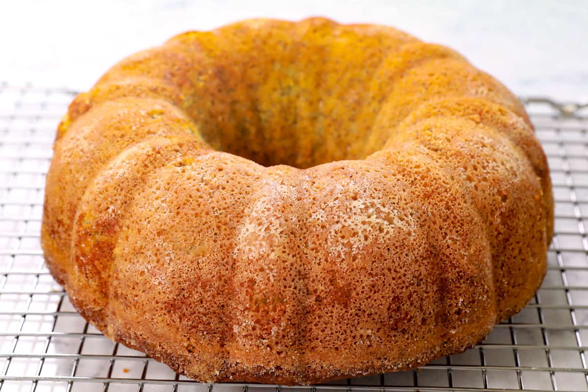 showing how to make lemon poppy seed cake by cooling the cake on a wire rack