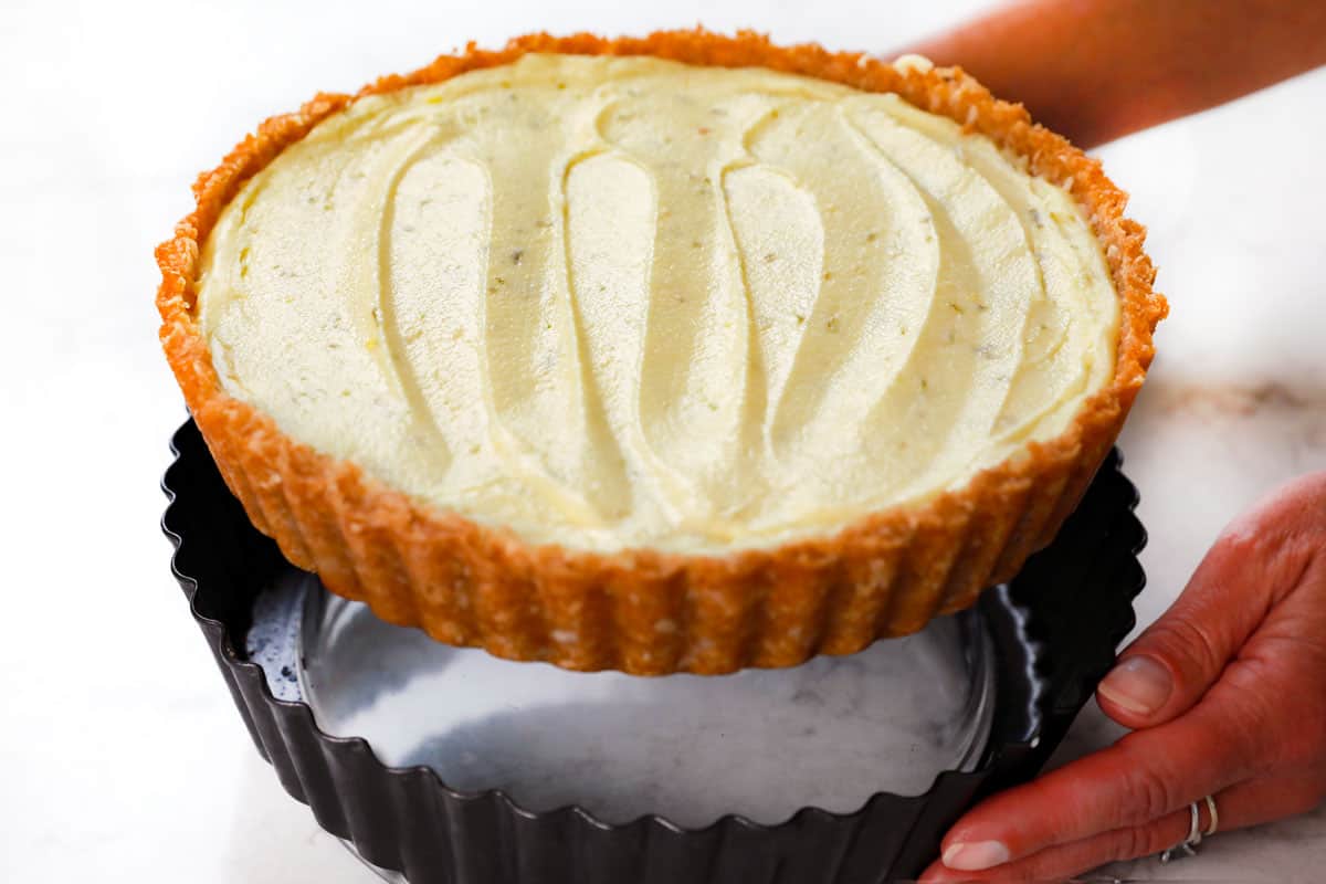 showing the best pan to use for making Key Lime Pie - a tart pan/quiche pan by removing the pie from the pan