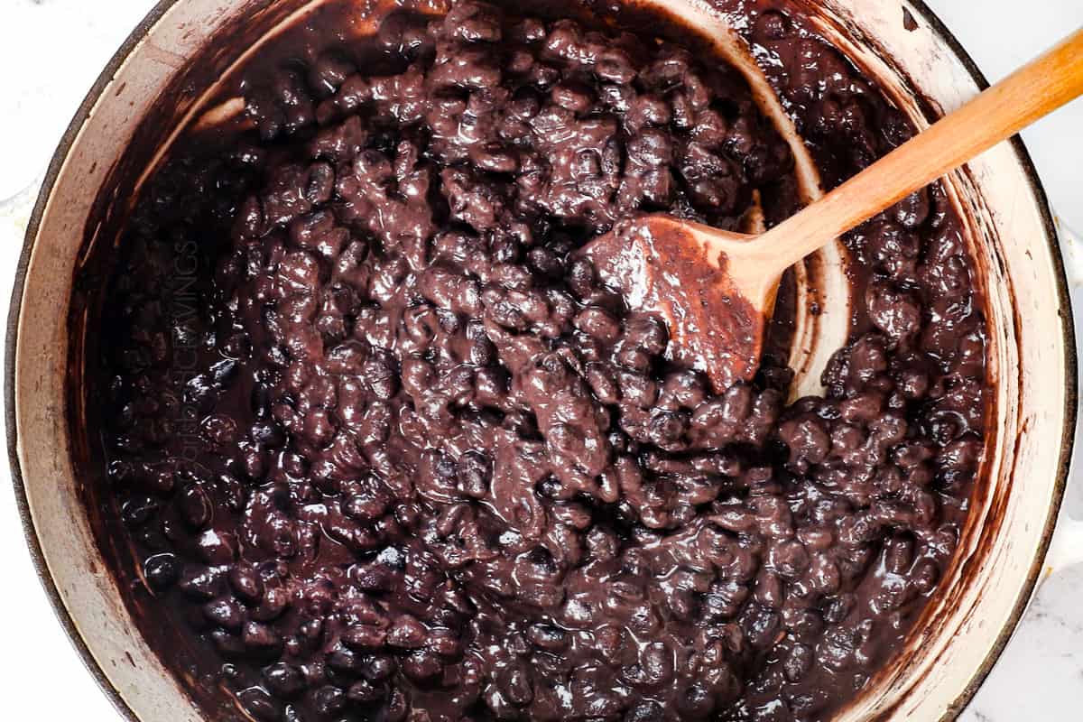 showing how to cook dried black beans by stirring in lime juice.