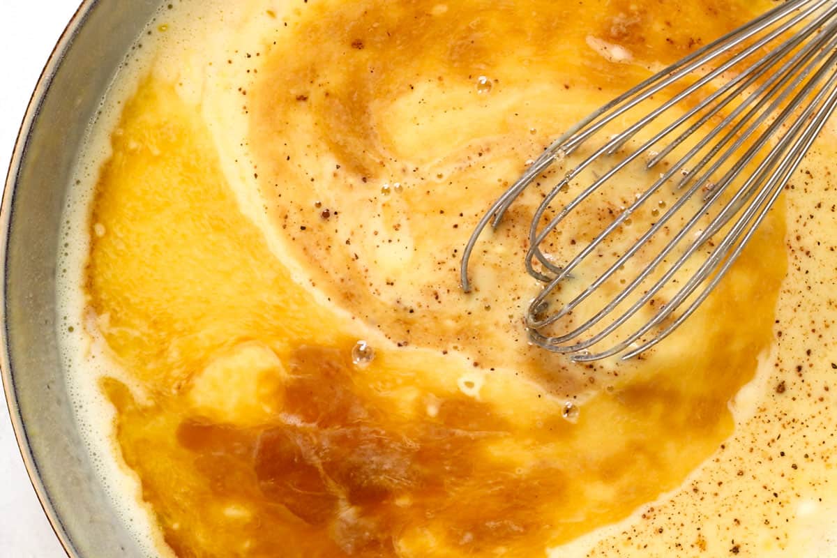 showing how to make French toast sticks by whisking eggs, milk, vanilla and flour together to make custard