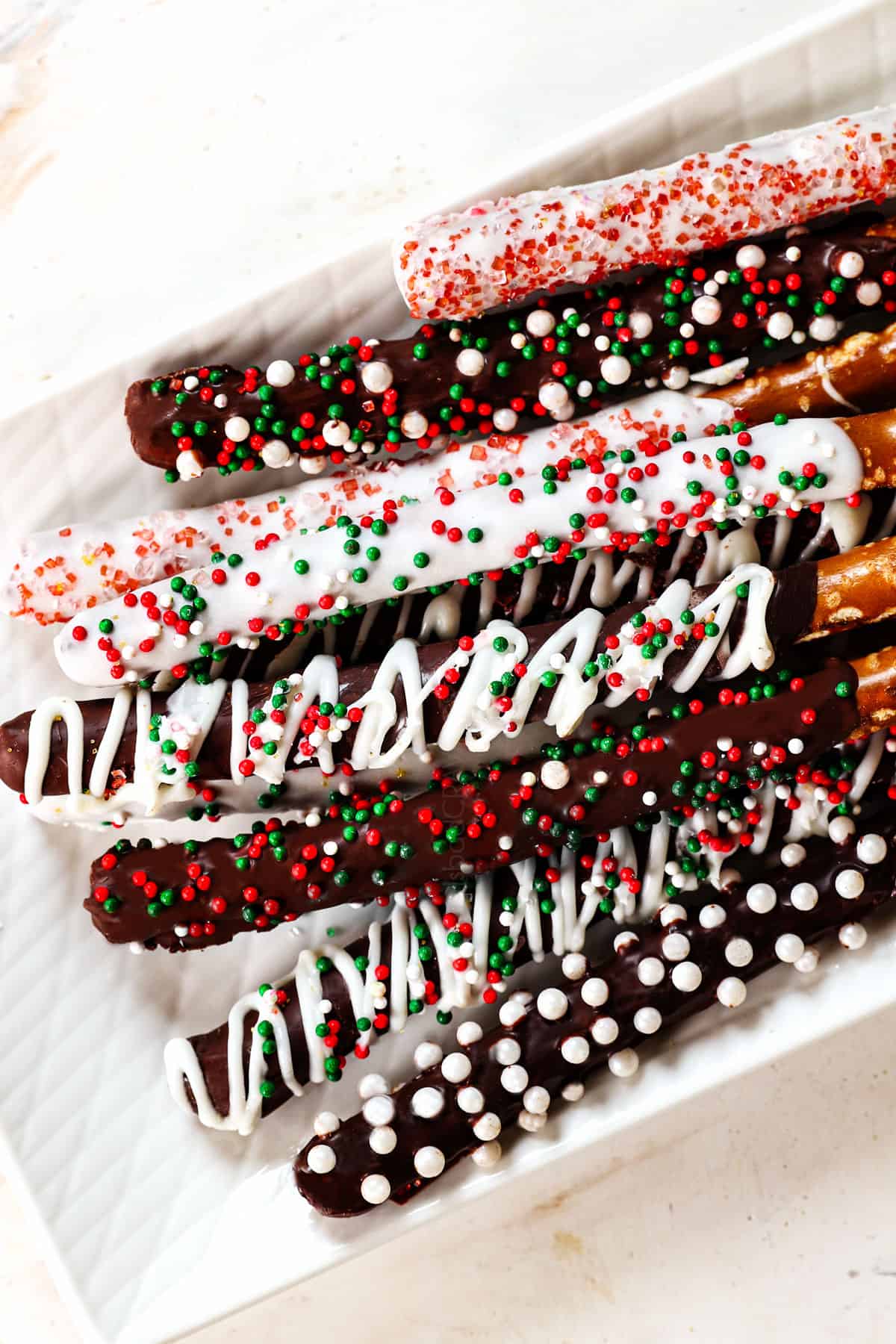 top view of chocolate dipped pretzels on a plate showing how to serve