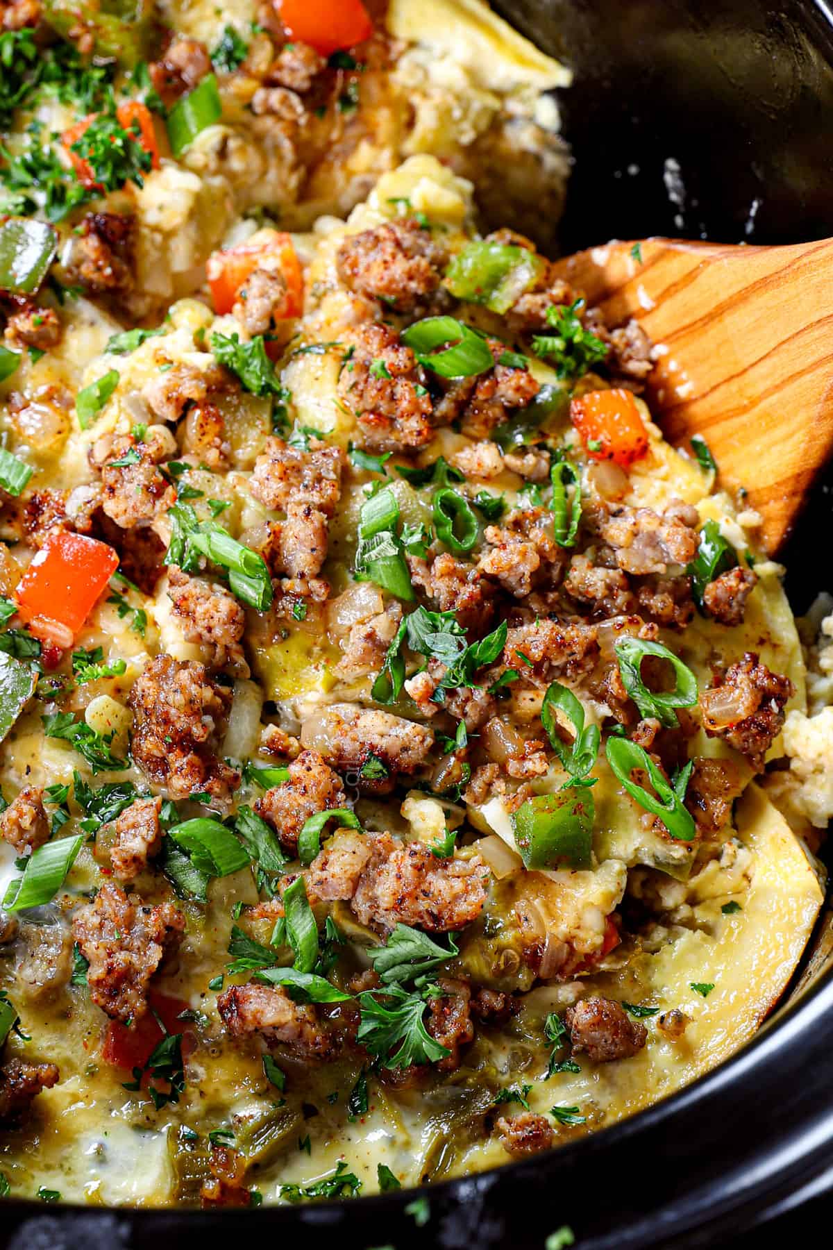 up close of serving crock pot breakfast casserole showing how creamy and cheesy it is