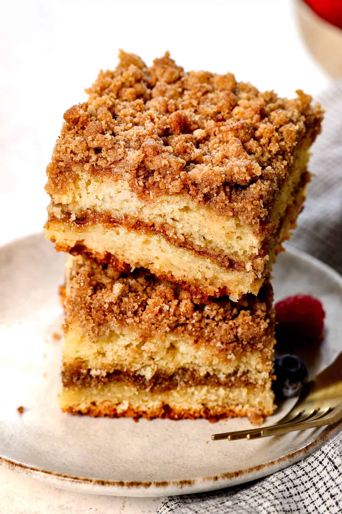 two slices of best coffee cake recipe stacked on top of each other showing the height, texture and topping